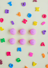 Fototapeta na wymiar photo of tasty pink marshmallows and colorful letters on the wonderful white background