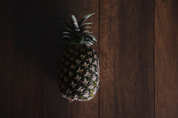 pineapple shelled Asian-style on the old wooden background.