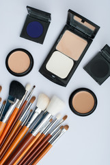 makeup brush and cosmetics, on a white background
