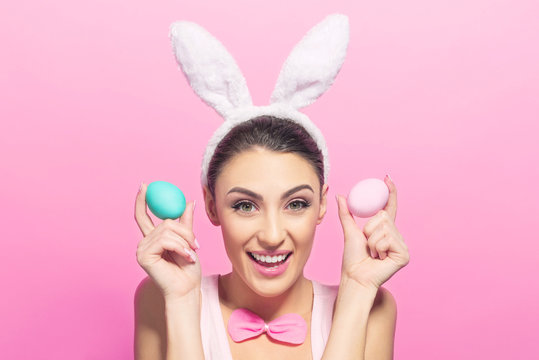 Playful young woman with Easter eggs