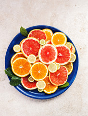 Variety  sliced citrus fruit orange, grapefruit, lemon on  wooden board. Top view.