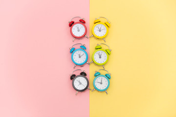 photo of colorful alarm clocks on the wonderful background in pop art style