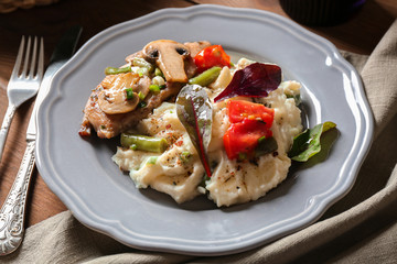 Tasty chicken marsala with vegetables on table
