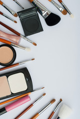 makeup brush and cosmetics, on a white background