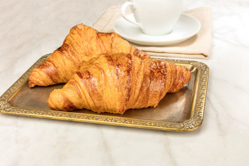 Fresh croissants on vintage tray, with copyspace