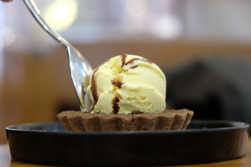 Brownie dessert on a white plate with chocolate syrup and vanilla ice, cream coffee shop in Shanghai