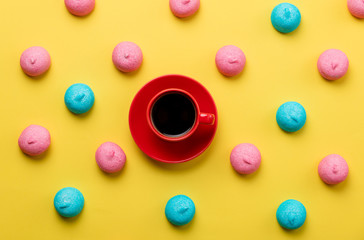 photo of tasty colorful marshmallows and cup of coffee on the wonderful yellow background