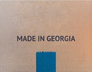 MADE IN GEORGIA written on brown cardboard box with copy-space for your text.