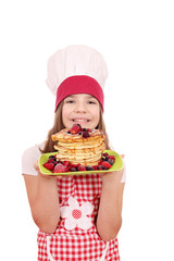 happy little girl cook with pancakes on plate