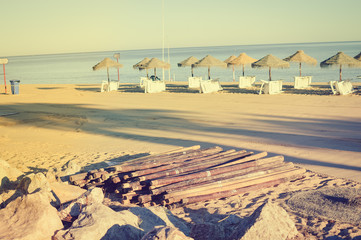 Blue sky and beach umbrella chair on beautiful tropical ocean coastline, sunny outdoors scenic background