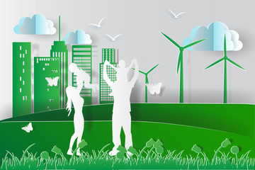green environment happy family having fun playing in the field.paper cut style,vector