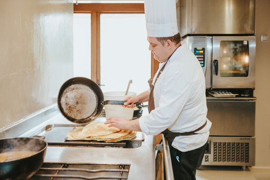 A person making the pancakes