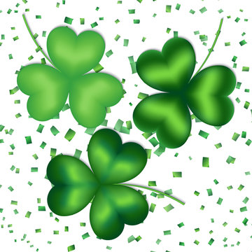 Collection of shamrocks of green hues on a white background with falling confetti
