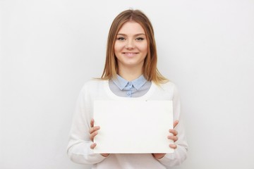 Fototapeta premium Young smiling woman show blank card or paper