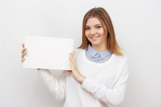 Young smiling woman show blank card or paper