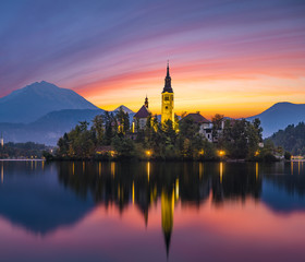 Fototapeta na wymiar Fairytale, multi-colored dawn over Lake Bled in Slovenia