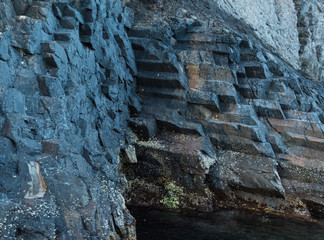 Basaltic wall of the rocky cliff