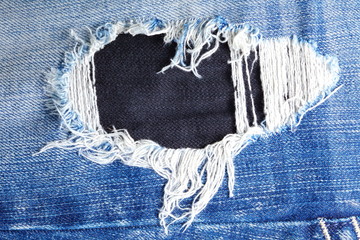 Blue denim jeans present the old denim look and old damaging fabric that shown detail of texture background. 