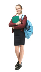 Obraz premium Beautiful schoolgirl in uniform standing on light background