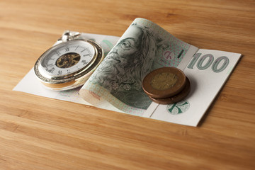 Time is money concept .Czech crowns on wooden background. Vintage watch.