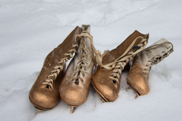 Vintage ice skates for figure skating lying on the snow
