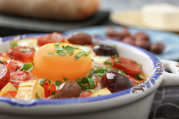 Bowl with tasty Spanish baked egg, closeup