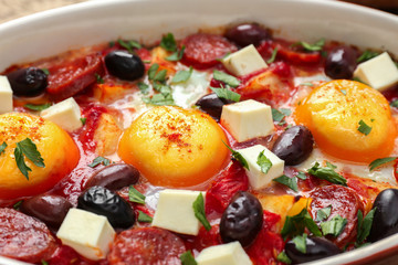 Baking dish with tasty Spanish baked eggs, closeup