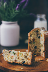 Easter cake divided on pieces over wooden board.