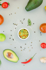Traditional mexican avocado - vegetarian dip surrounded by its ingredients.