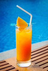 orange juice in a glass on the wooden table