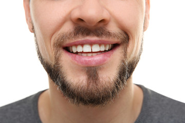 Obraz premium Smiling young man on white background, closeup