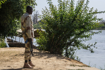 A security guard patrolling on the niger river, niger, west africa