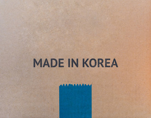MADE IN KOREA written on brown cardboard box with copy-space for your text.