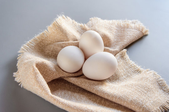 White fresh eggs on gray background.  Rural still life, natural organic healthy food with free space. Close up