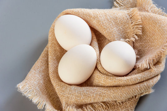 White fresh eggs on gray background.  Rural still life, natural organic healthy food with free space. Close up