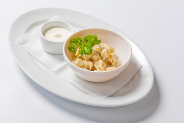 Meat dumplings - russian pelmeni, ravioli with meat in a deep bowl
