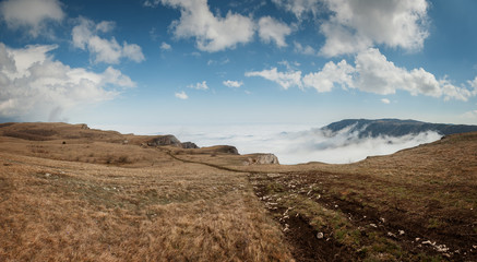Mountains under the blue sky with clouds