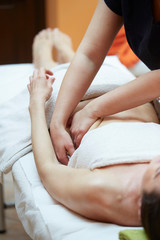 Obraz na płótnie Canvas beauty, holidays and spa concept - woman in spa salon getting massage