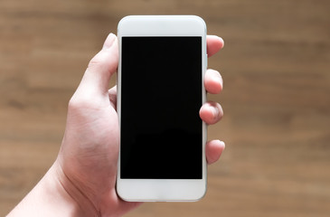 Man's hand holding white smart phone  in vertical direction