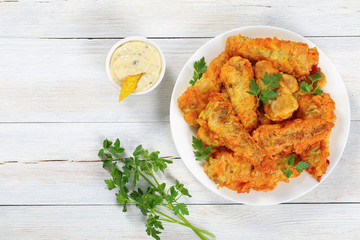 fried fish decorated with parsley, top view
