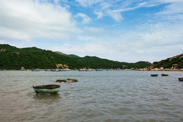 Fototapeta na wymiar Fishing round boats in the sea with hills view in Vietnam