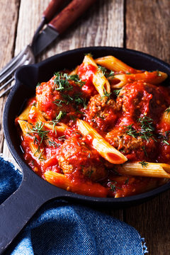 Meatball penne pasta with spicy tomato sauce and dill