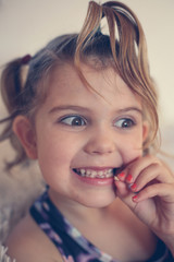 Little girl with loose tooth.