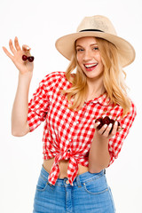 Obraz na płótnie Canvas Portrait of beautiful country girl with cherry over white background.