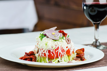 Fresh Salad With Cucumber, Tomatoes, White Cheese, Grilled Pepper, Onion And Glass Of Red Wine