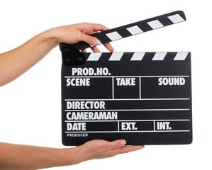 Female hand holding black with white letters cracker isolated on white.