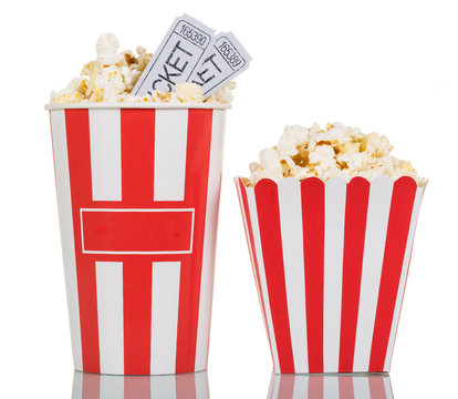 Two large striped boxes filled with popcorn, movie tickets on white.