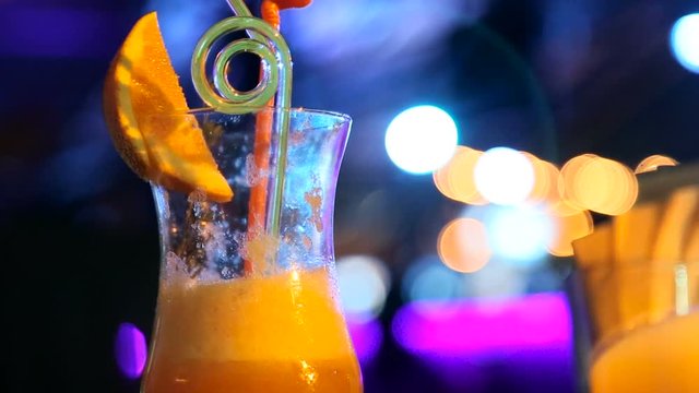 Cocktail in a bar on a background of flashing light