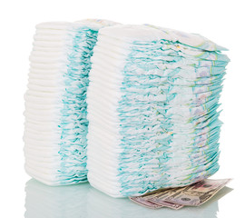 Two stacks of disposable diapers and money isolated on white.