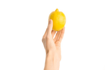 Healthy eating and diet Topic: Human hand holding yellow lemon isolated on a white background in the studio, first-person view - 143038993